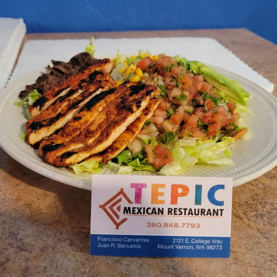 Grilled chicken and steak served over lettuce with pico de gallo at Tepic Mexican Restaurant.